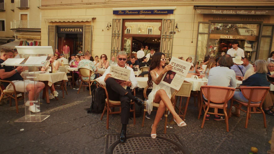 couple-reading-wedding-journal-in-the-crowd