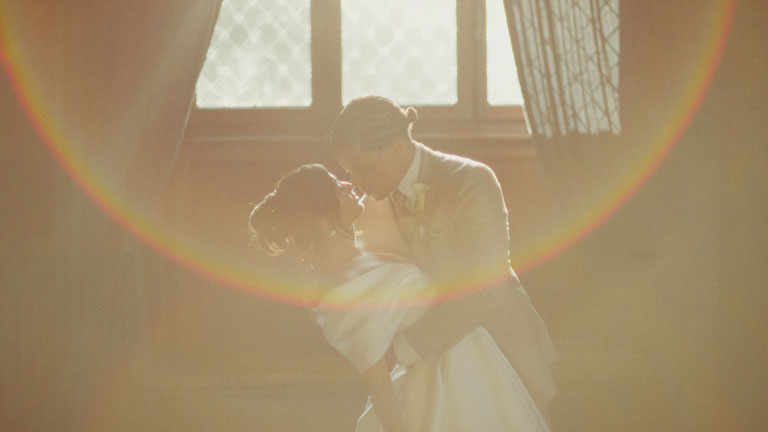 couple kiss with a vintage flare